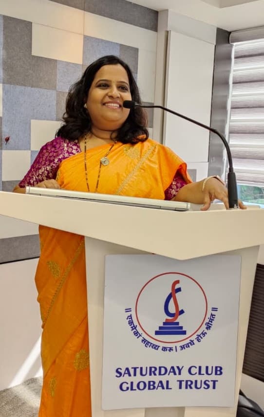 Suvarna anchoring an event from the podium