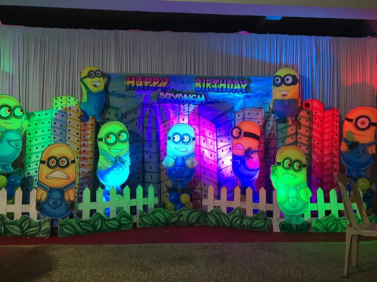 Minion-themed kids birthday stage with illuminated cutouts
