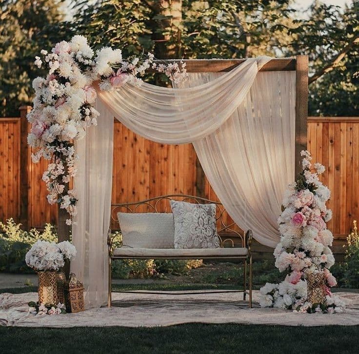 Ornate wedding stage backdrop with warm lighting