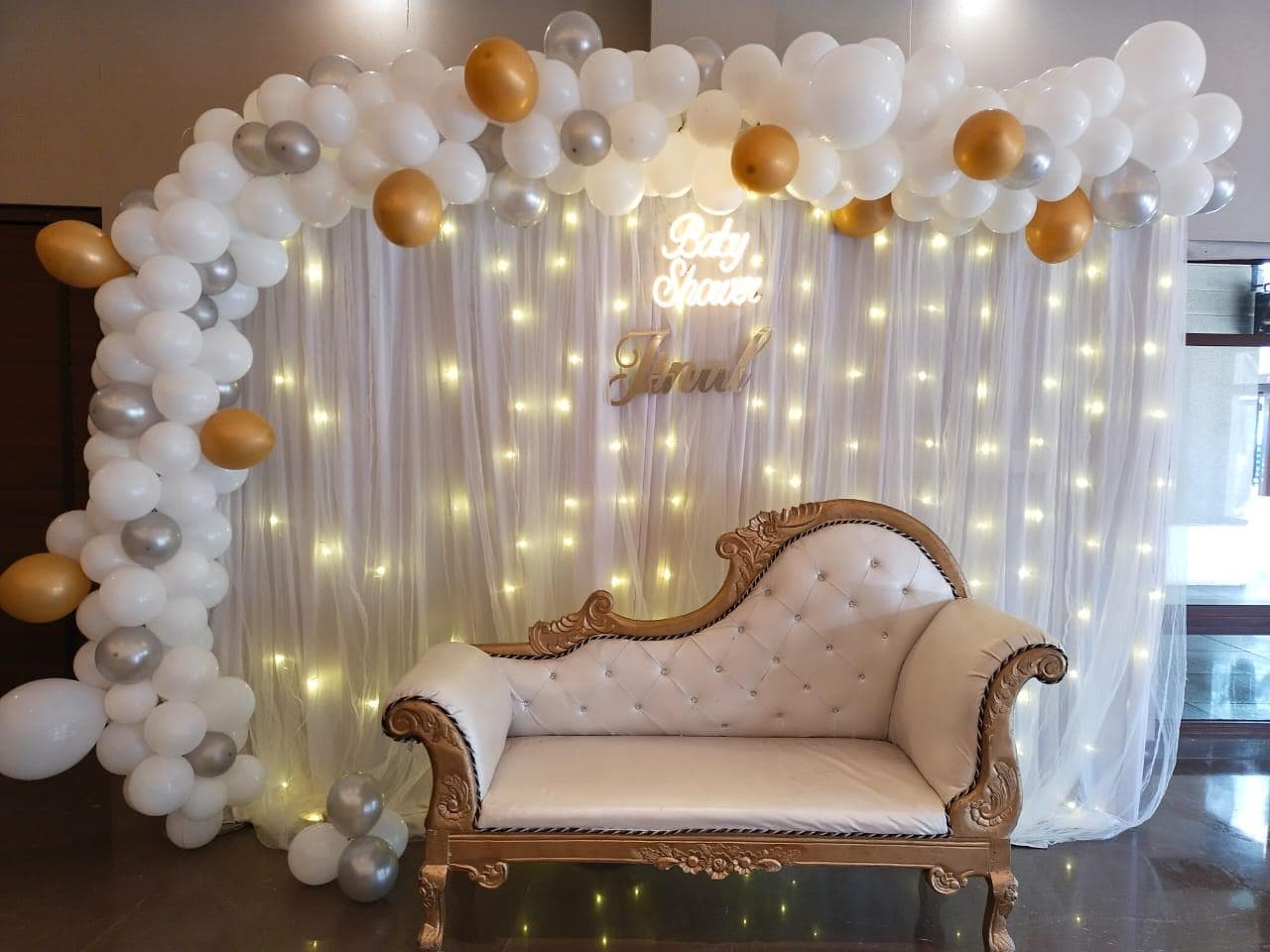 Elegant baby shower photo backdrop with chaise and balloon garland